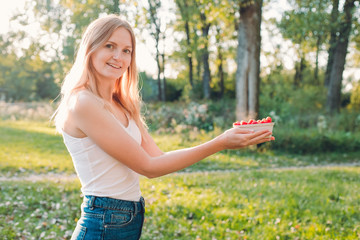 Naklejka premium Woman hold paper box with raspberries. Healthy, organic food concept. Harvest of fruits