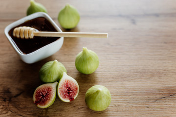 Figs and honey in a white bowl