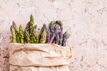 Top view of bunch of fresh purple and green asparagus spears