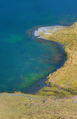 aerial view on a beautiful blue lake and its banks with yellow grass