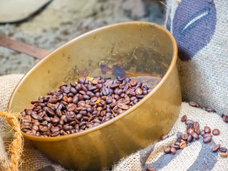 Freshly roasted coffee beans in a brass bowl