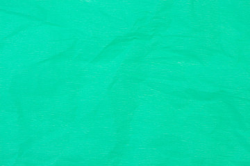 Crumpled paper color of caribbean green. Top view.
