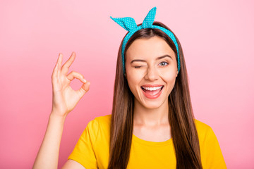 Close up pin-up photo of charming enjoying rejoicing joyful carefree girl showing you okay in order...
