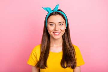 Portrait of charming youngster looking with toothy smile wearing yellow t-shirt isolated over pink background