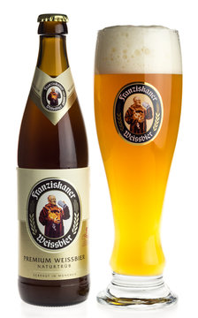 GRONINGEN, NETHERLANDS - FEBRUARY 6, 2018: Bottle and glass of German Franziskaner wheat beer isolated on a white background