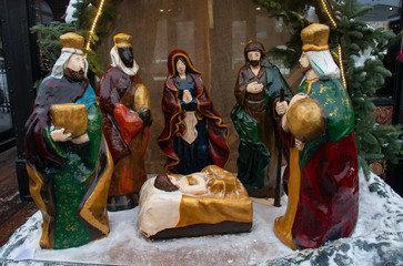 Nativity scene with figures including Jesus, Mary, Joseph, sheep and magicians at the fair