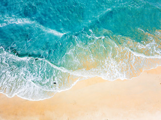 Fototapety  Top view of blue aqua sea water. Capture by drone. Capture sea wave and beach in summer by drone.