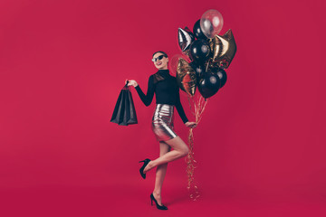 Full length body size view of nice attractive cheerful glad fascinating lady holding in hands bags air balls enjoying autumn fall sale isolated on maroon burgundy marsala red pastel color background