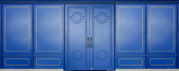 blue door and wall modern and vintage style decorated with golden cornice © Phawat