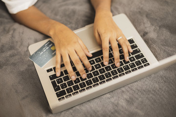 Fototapeta na wymiar Hand writing on laptop on grey background