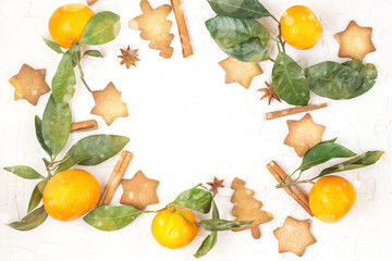 Border of Christmas star cookies with spices and mandarin on white background with copyspace.