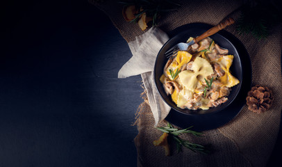Colorful farfalle pasta with chanterelles and cream sauce.