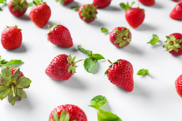 Fototapeta na wymiar Many sweet ripe strawberries with mint on white background