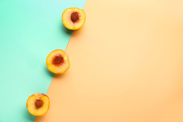 Sweet ripe peaches on color background