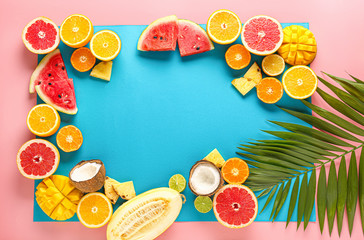 Frame made of ripe fruits on color background