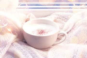 Cozy winter, autumn composition. A cup of hot coffee by the window.