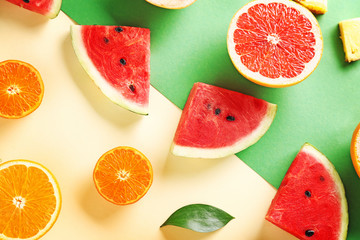 Sweet ripe fruits on color background