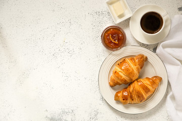 breakfast with croissants. fresh crispy croissants and coffee on a light .background, top view..