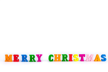 Creative layout of words merry christmas made of wooden multi-colored letters on white background. New Year concept with free space for note and text
