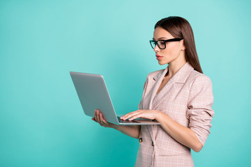 Profile side view portrait of nice attractive lovely gorgeous pretty content smart clever straight-haired lady working remote isolated over bright vivid shine blue green teal turquoise background