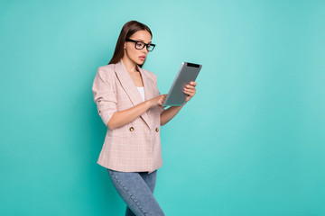 Naklejka premium Profile side view portrait of nice-looking attractive pretty focused concentrated smart clever straight-haired lady browsing news isolated over bright vivid shine blue green teal turquoise background