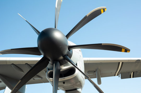 Aircraft propeller - detail of miliary aircraft and airplane. Clear blue sky in the background	