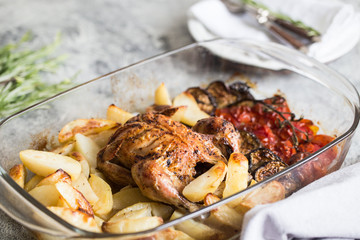 Baked whole chicken with potatoes, eggplant and cherry tomatoes. healthy dinner