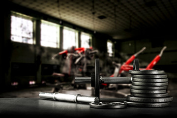 Gym interior and dumbbells on black desk with free space for your decoration. 