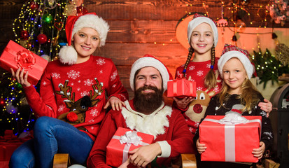 Obraz na płótnie Canvas Happy holidays. Spend time with your family. Parents and children opening christmas gifts. Christmas tradition. Boxing day. Father bearded man and mother with cute daughters christmas tree background