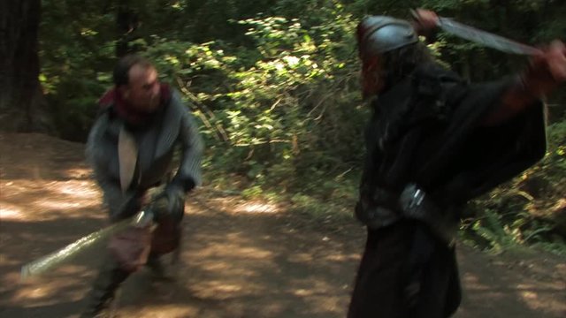 Medieval warriors hack away at each other with swords in a vicious battle