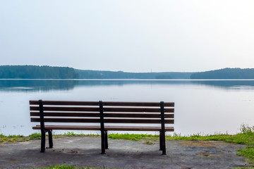 Naklejka na ściany i meble empty bench on the lake, summer morning