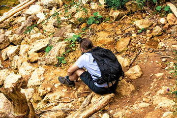Hidden on rocks photographer waiting for shooting photography. Travel and hobby lifestyle. Active...