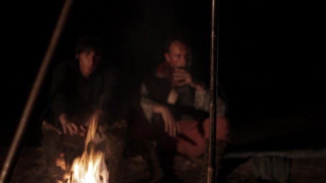 Two medieval knights falls asleep near a campfire
