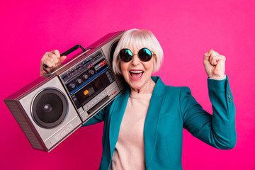 Close-up portrait of her she nice attractive cheerful cheery glad gray-haired lady carrying boombox having fun time isolated on bright vivid shine vibrant pink fuchsia color background