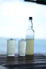 Fresh juice in a glass and a bottle of old wine reuse