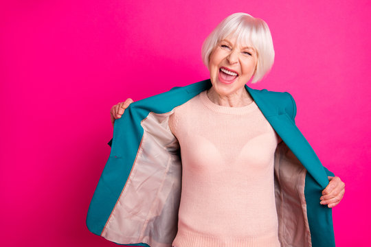 Portrait of her she nice attractive lovely cheerful cheery glad funky gray-haired lady wearing blue green jacket having fun isolated on bright vivid shine vibrant pink fuchsia color background