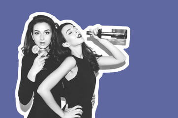 Two beautiful women in black night fashion dress posing isolated on a white gray background. Pretty...