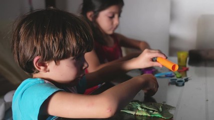 children play with plasticine figures at home while watching television