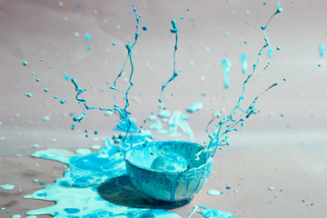 Blue paint splash and cup abstract background