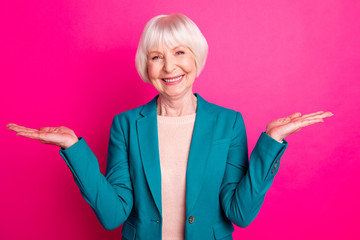Portrait of her she nice attractive lovely cheerful cheery gray-haired lady holding invisible objects on palms new novelty isolated over bright vivid shine vibrant pink fuchsia color background