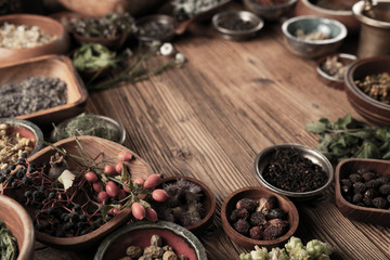 Spices theme. Collection of spices in bowls on wooden rustic table. Place for text or typography.
