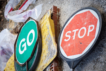 stop and go signs lying on street