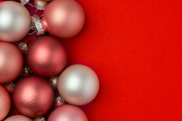 Christmas New years car in minimalist style red pink white pearl decorative tree balls on crimson background. Template for poster banner with copy space