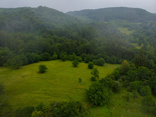 Aerial view over mountain road going through forest landscape. Transylvania, Romania