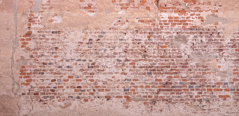 Textured orange wall background plastered over bricks