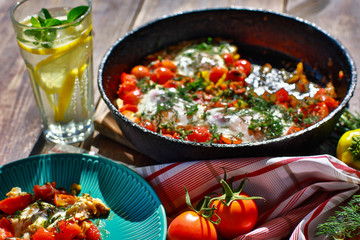 fried eggs with vegetables in a pan