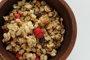 Healthy breakfast, granola in wooden bowl
