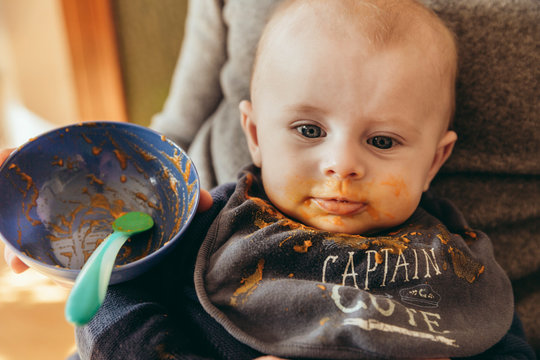 Sattes Baby nach erstem Babybrei auf Papas Scho&szlig;