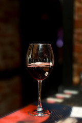 glass of red wine on table in bar