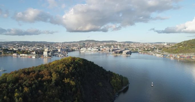 Cinema 4K drone shot with parallax motion of Hoved&oslash;ya island, the Oslofjord and the new Bj&oslash;rvika quarter project with the Lambda Edvard Munch Museum and Opera House in autumn fall, in Oslo Norway.